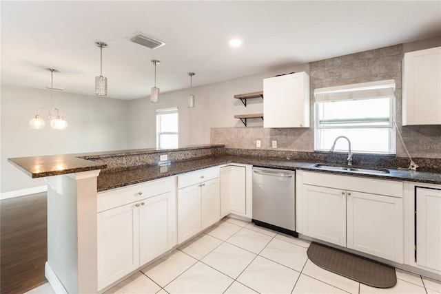 kitchen with kitchen peninsula, dishwasher, decorative light fixtures, and plenty of natural light