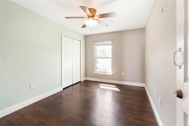 unfurnished bedroom with a closet, ceiling fan, and dark hardwood / wood-style floors