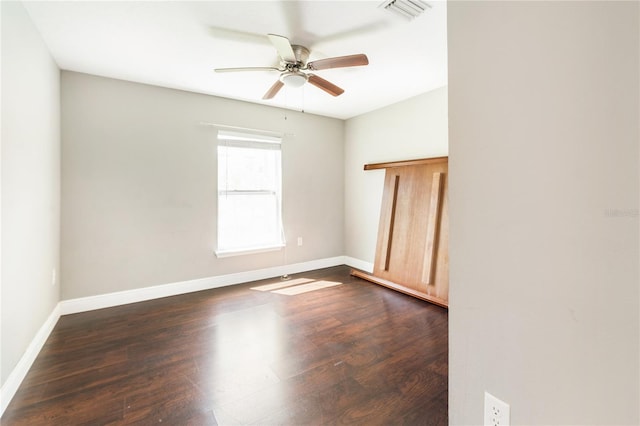 unfurnished room featuring ceiling fan and dark hardwood / wood-style flooring