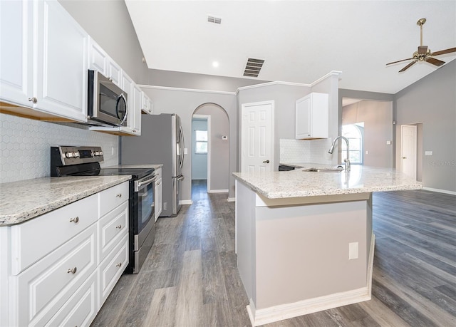 kitchen with white cabinets, lofted ceiling, ceiling fan, and appliances with stainless steel finishes