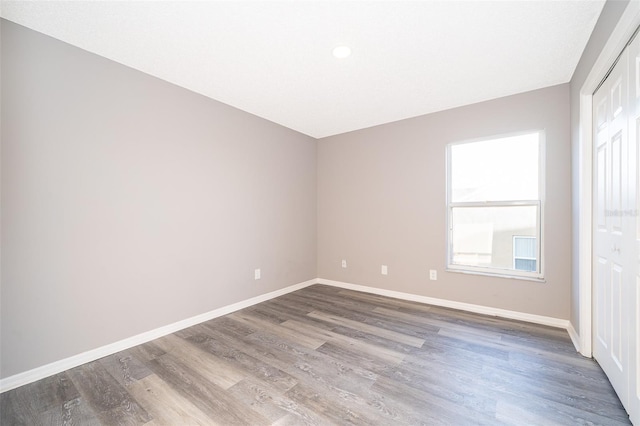 empty room with wood-type flooring