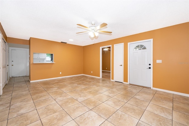 tiled foyer entrance with ceiling fan