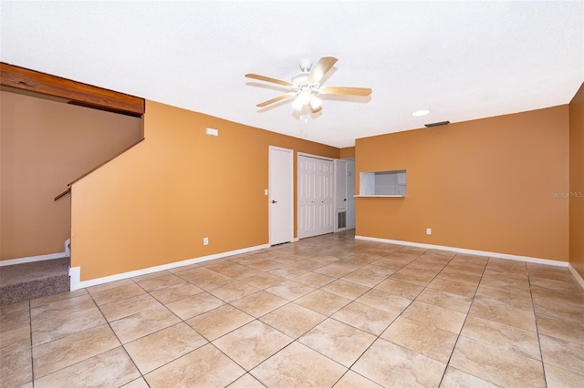 spare room featuring light tile patterned flooring and ceiling fan