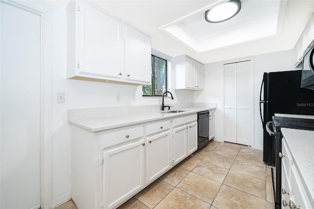 kitchen featuring black dishwasher, sink, range with electric stovetop, and white cabinets