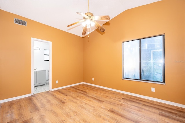 spare room with ceiling fan, hardwood / wood-style flooring, and lofted ceiling