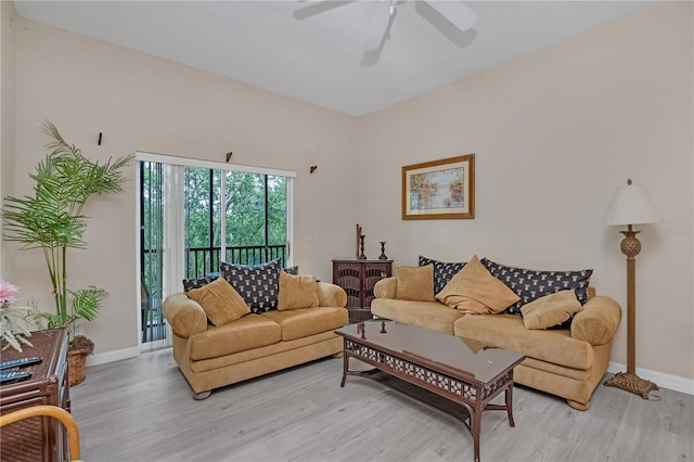 living room with light hardwood / wood-style floors and ceiling fan