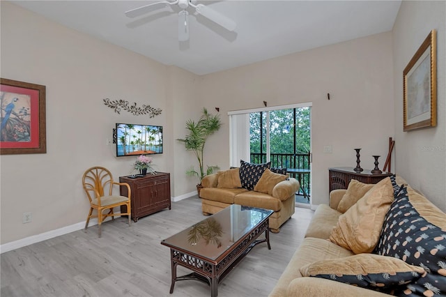 living room with light hardwood / wood-style floors and ceiling fan