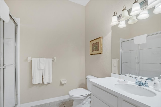 bathroom featuring tile patterned flooring, vanity, toilet, and a shower with shower door