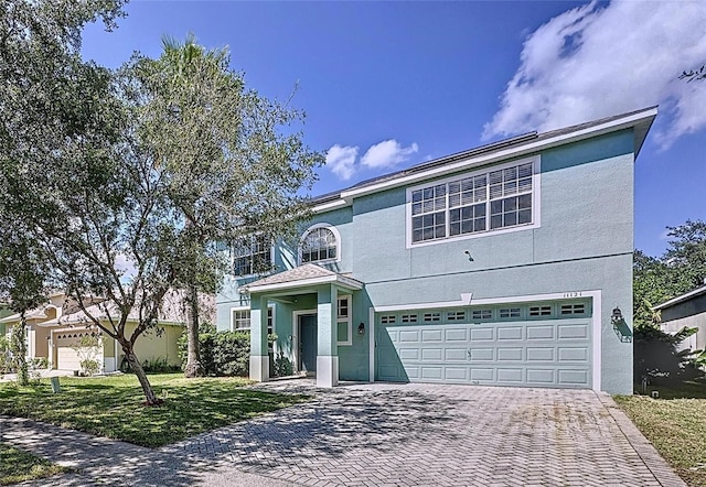 front facade with a front lawn and a garage