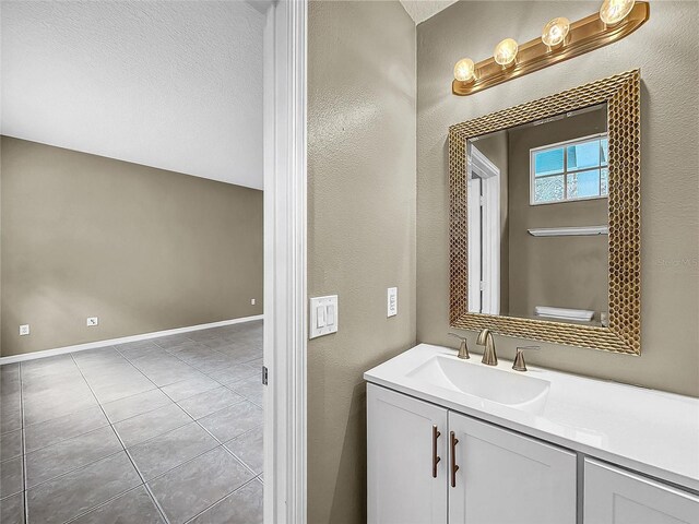 bathroom with tile patterned floors and vanity