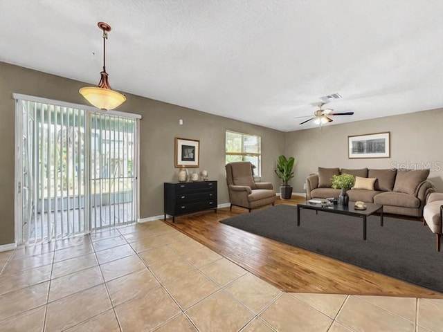 living room featuring light wood-type flooring and ceiling fan