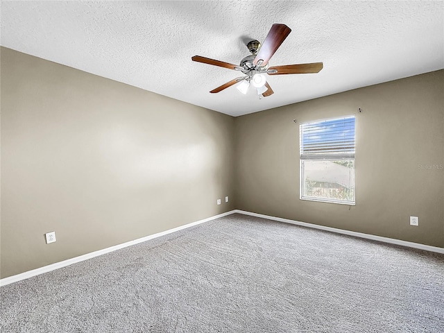 carpeted empty room featuring ceiling fan and a textured ceiling