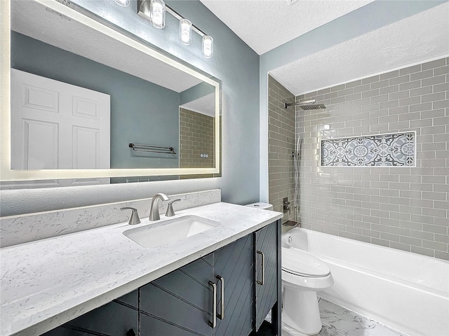 full bathroom featuring a textured ceiling, tiled shower / bath, vanity, and toilet