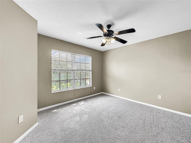 carpeted spare room featuring ceiling fan and a textured ceiling