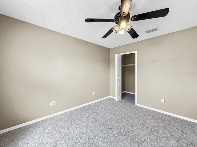 unfurnished bedroom featuring a textured ceiling, carpet flooring, ceiling fan, and a closet