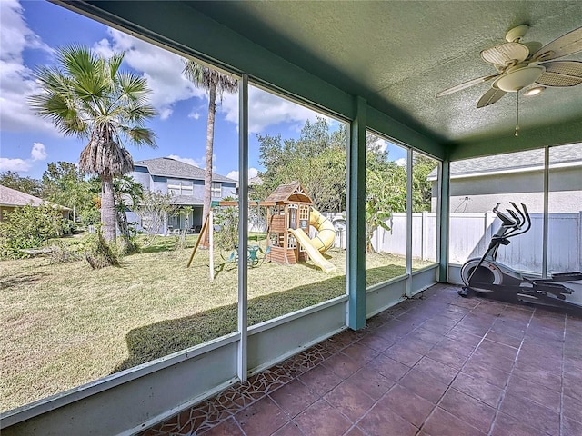 unfurnished sunroom with ceiling fan