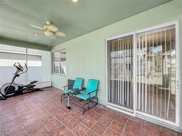 sunroom / solarium featuring ceiling fan