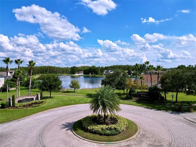 view of home's community featuring a water view and a yard