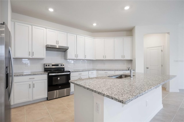 kitchen featuring sink, stainless steel appliances, white cabinets, and an island with sink