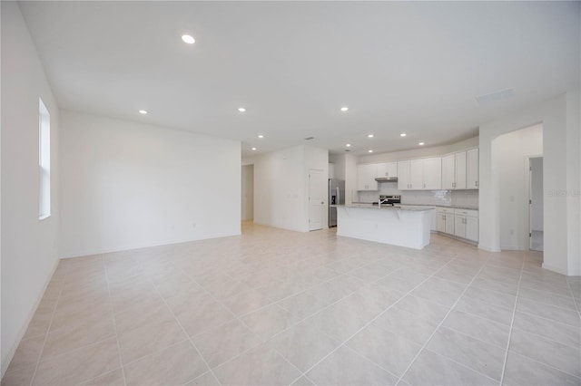 unfurnished living room featuring light tile patterned floors