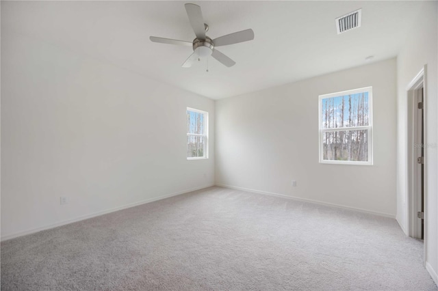 carpeted spare room with ceiling fan