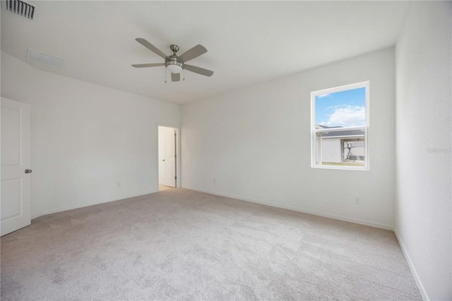 carpeted spare room featuring ceiling fan