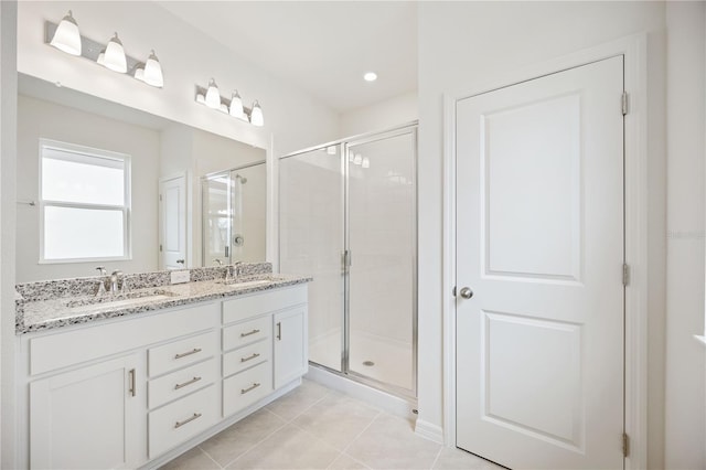 bathroom with vanity, walk in shower, and tile patterned flooring