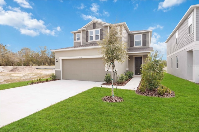 view of front of home with a garage and a front lawn