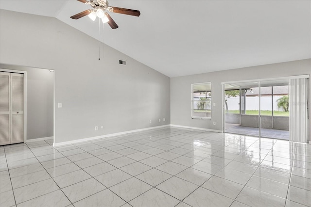 tiled empty room featuring ceiling fan and high vaulted ceiling