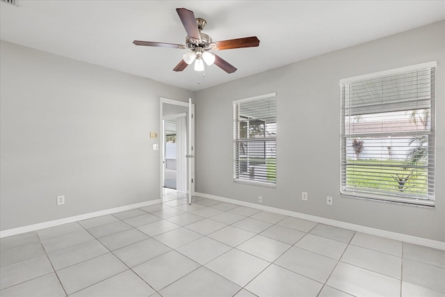 spare room featuring light tile patterned floors and ceiling fan