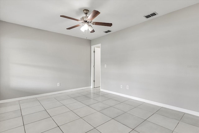 spare room with ceiling fan and light tile patterned flooring