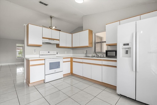 kitchen with light tile patterned flooring, vaulted ceiling, white cabinetry, white appliances, and ceiling fan