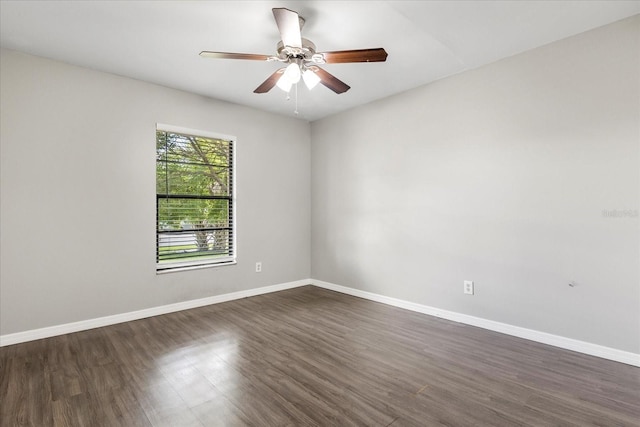 spare room featuring ceiling fan and dark wood-type flooring