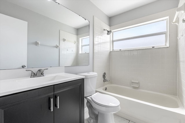 full bathroom with a wealth of natural light, tiled shower / bath combo, vanity, and toilet