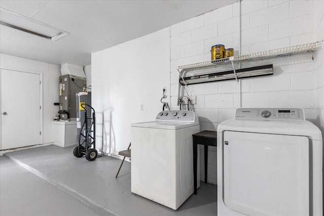 clothes washing area featuring independent washer and dryer