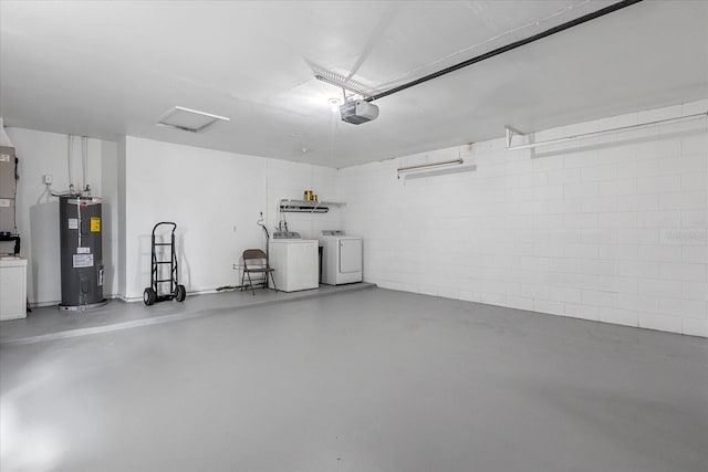 garage featuring washer and clothes dryer, a garage door opener, and water heater