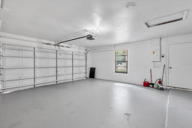 garage with a garage door opener and electric panel