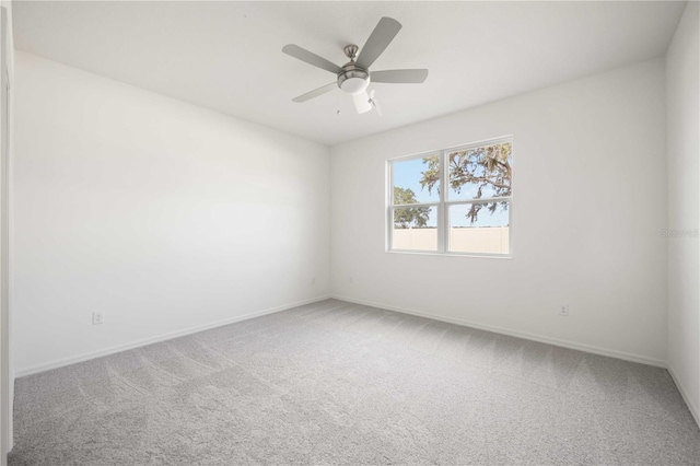 unfurnished room featuring ceiling fan and carpet