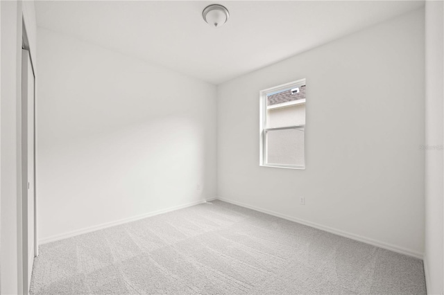 spare room with light carpet