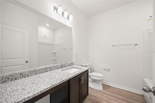 full bathroom featuring vanity, hardwood / wood-style flooring, toilet, and shower / bath combination