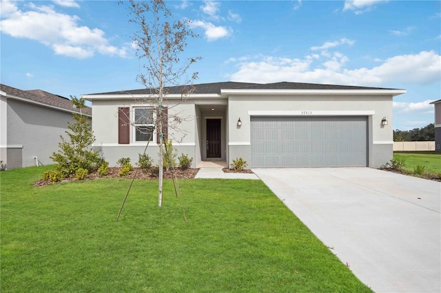 view of front of home featuring a garage and a front lawn