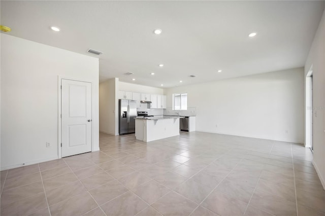 unfurnished living room with light tile patterned floors