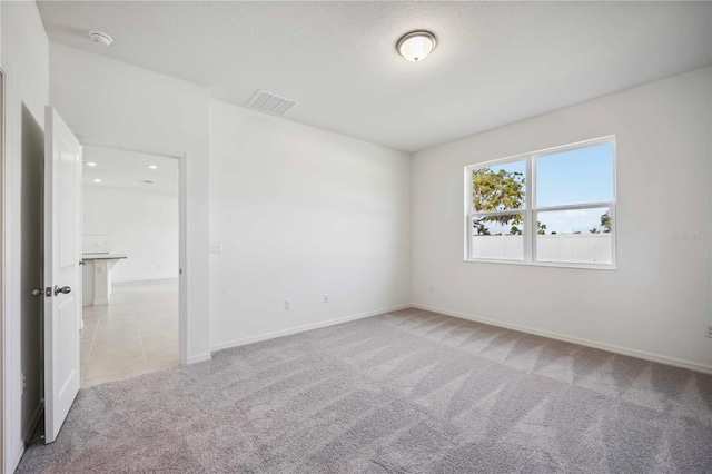 empty room featuring light carpet