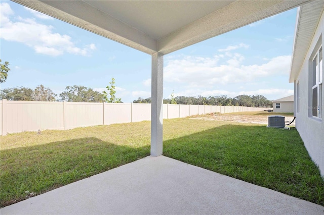 view of yard featuring central AC unit and a patio