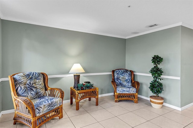 sitting room with tile patterned floors, baseboards, visible vents, and ornamental molding