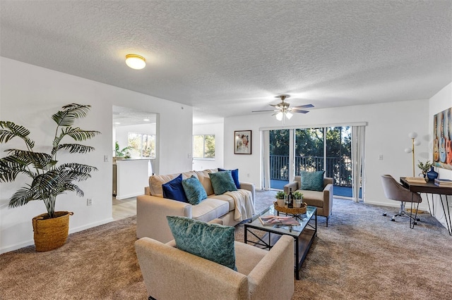 carpeted living room featuring a ceiling fan, a textured ceiling, and baseboards