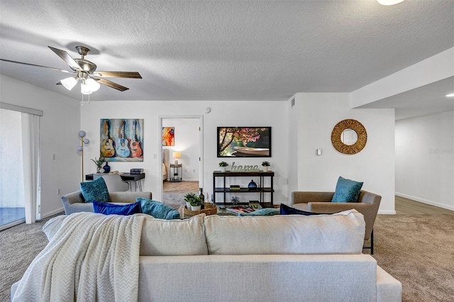 living room with ceiling fan, carpet floors, a textured ceiling, and visible vents