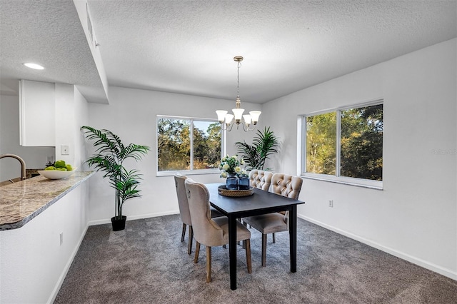 dining room with a chandelier, a wealth of natural light, and dark carpet