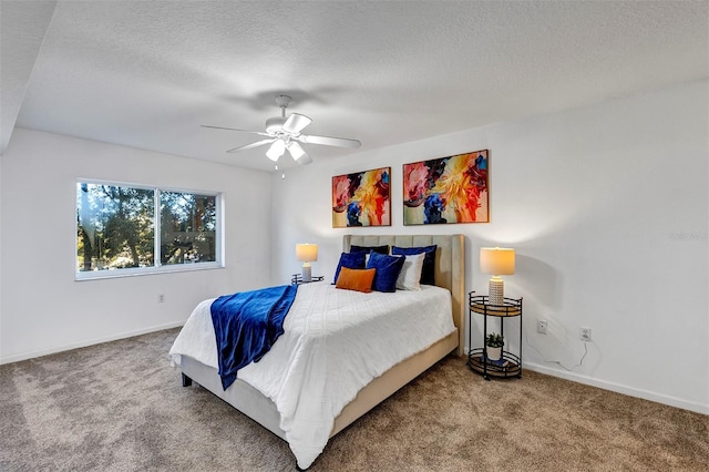 carpeted bedroom with a textured ceiling, ceiling fan, and baseboards