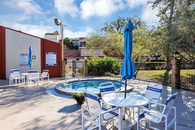 view of swimming pool with fence